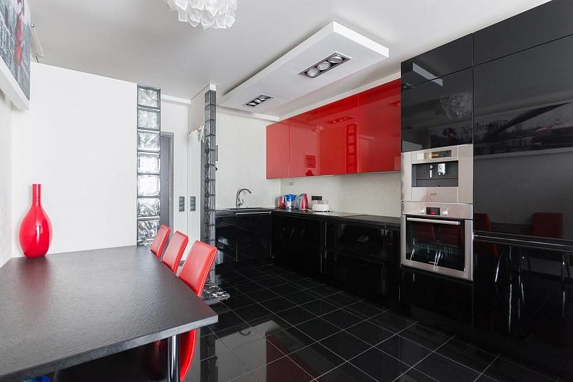Kitchen with white walls and a red accent